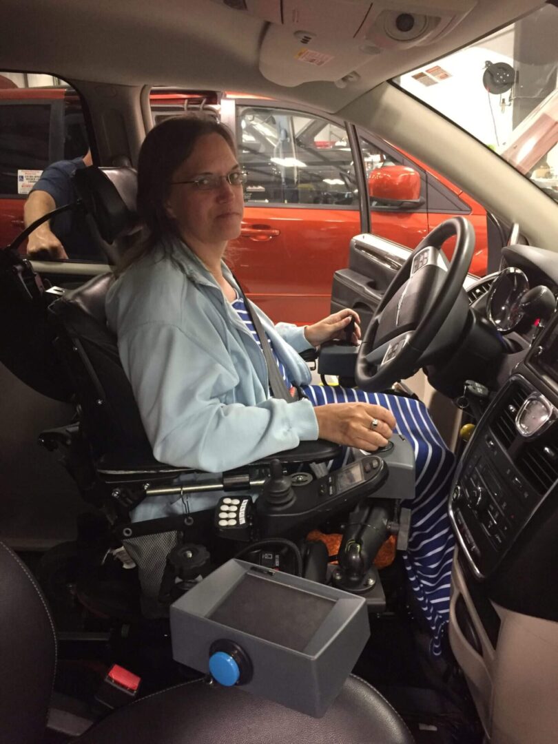 A woman sitting on the driver’s seat